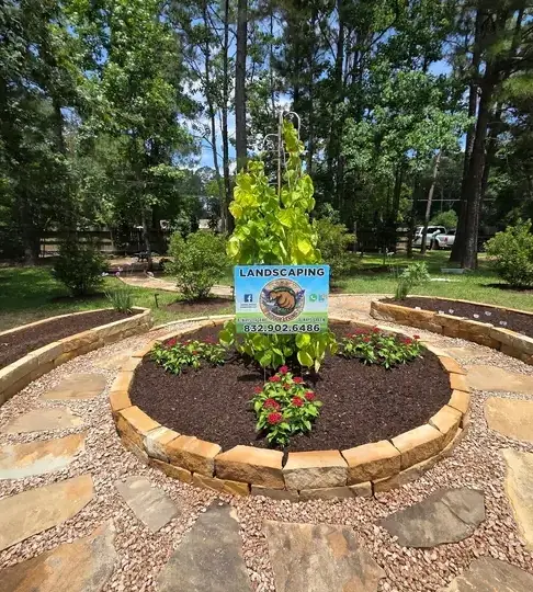 Flagstone patio with a raised planter bed and a Green Midas Services sign in the middle
