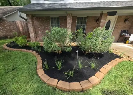 Curved flower bed edged in brick