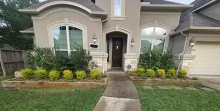 Front yard with a river rock ring around a tree (photo 5 of 8)