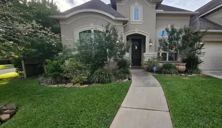 Front yard with a river rock ring around a tree (photo 6 of 8)