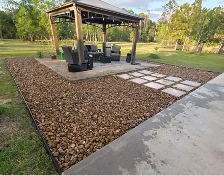 Gazebo seating area surrounded by river rock