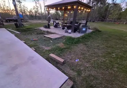 Gazebo seating area surrounded by river rock (photo 6 of 6)