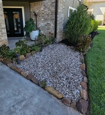 Rounded shrubs in a mulched bed along a house (photo 5 of 5)