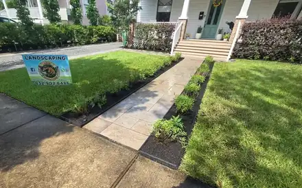 Stone walkway beside a mulched bed with a brick border (photo 2 of 8)