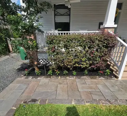 Stone walkway beside a mulched bed with a brick border (photo 8 of 8)